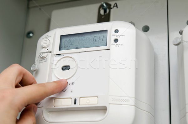 Stock photo: Electric energy meter. Electrical technician servicing unit