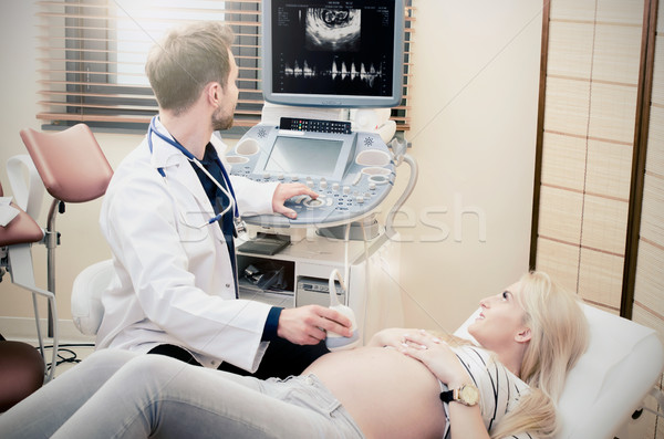 Pregnant woman at the doctor. Ultrasound diagnostic machine. Stock photo © simpson33