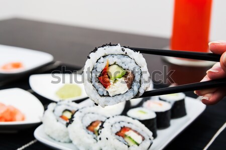 Hand holding sushi on sticks Stock photo © simpson33