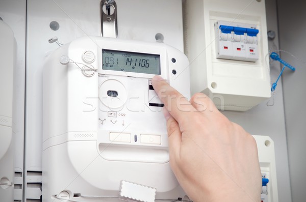 Electric energy meter. Electrical technician servicing unit Stock photo © simpson33