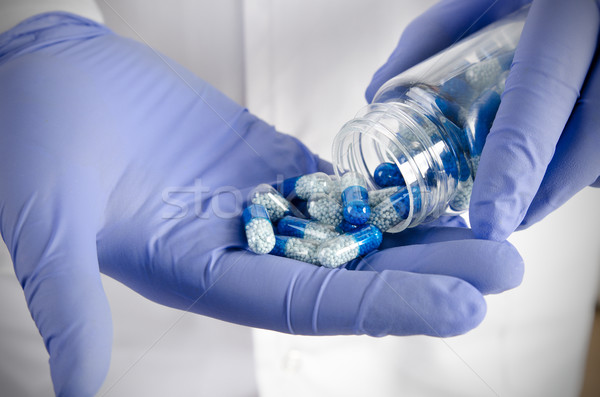 Person pouring out pills on hand Stock photo © simpson33