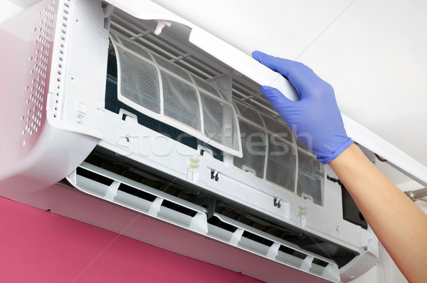 Air conditioner cleaning. Man checks the filter. Stock photo © simpson33