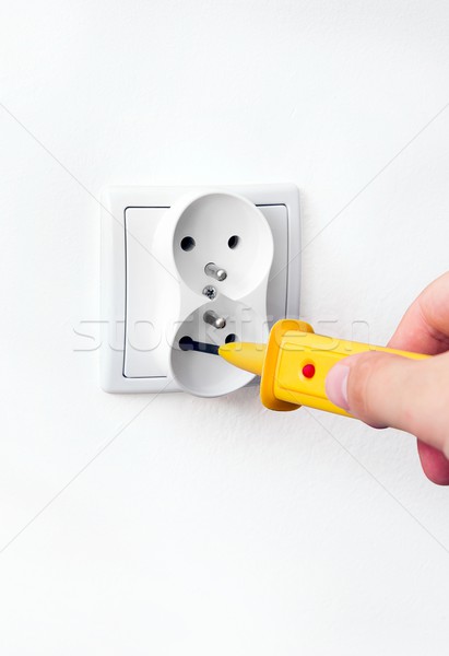 Man checking power in socket with detector Stock photo © simpson33
