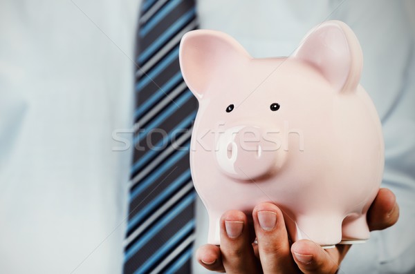 Człowiek biznesu banku piggy strony oszczędności ceny Zdjęcia stock © simpson33