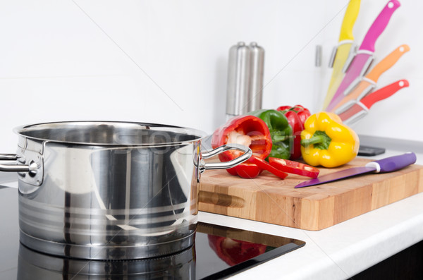Pot and vegetables in modern kitchen with induction stove Stock photo © simpson33