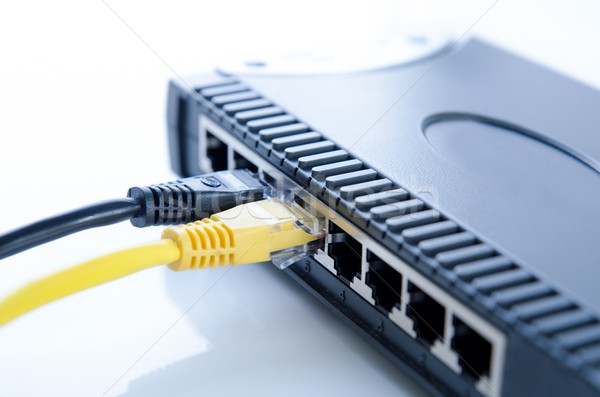 Network switch device and ethernet cables on white Stock photo © simpson33