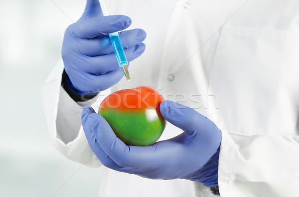 Technician uses a syringe. Genetic modification of fruits and ve Stock photo © simpson33