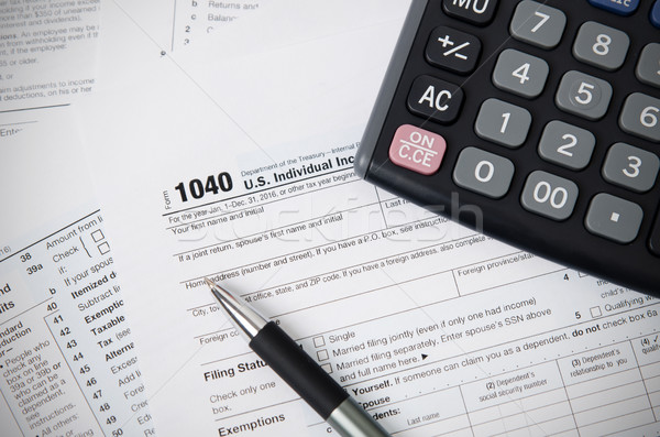 US tax form 1040 with pen and calculator Stock photo © simpson33