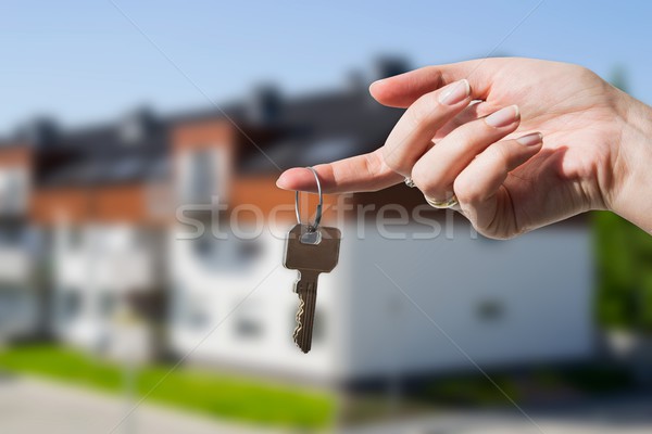 Woman's hand holding keys to new house Stock photo © simpson33
