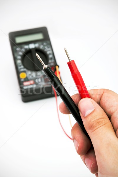 Multimeter with black and red wire in hands Stock photo © simpson33