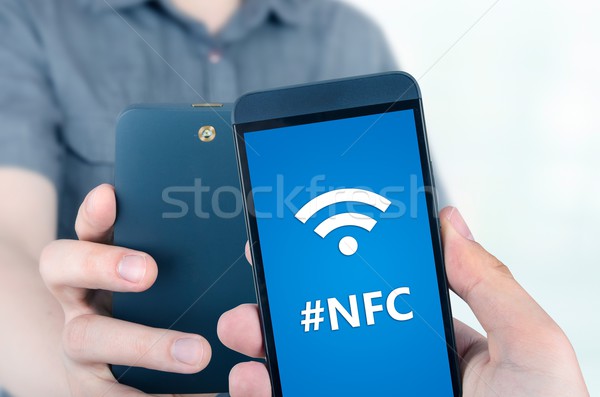 Hand holding smartphone with NFC technology - near field communi Stock photo © simpson33