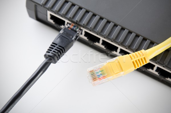 Network switch device and ethernet cables on white Stock photo © simpson33