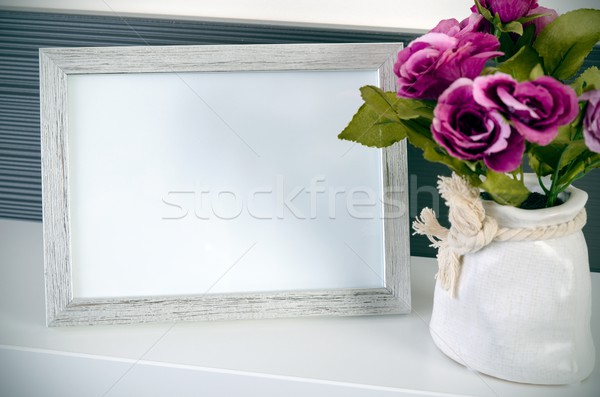 Photo frame stands on a shelf next to the flowers Stock photo © simpson33