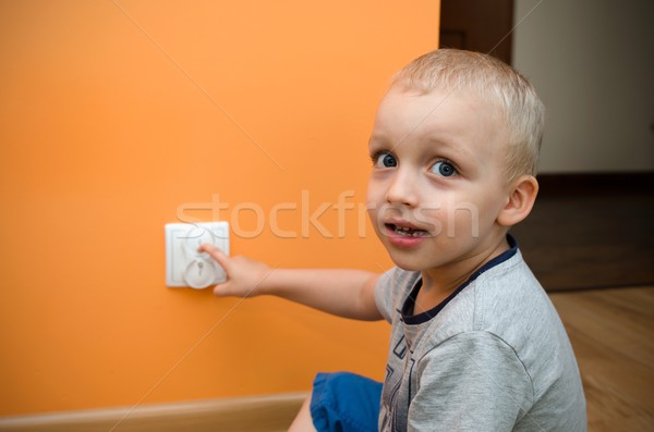 Child near to the socket. Electrical security of ac power for ba Stock photo © simpson33