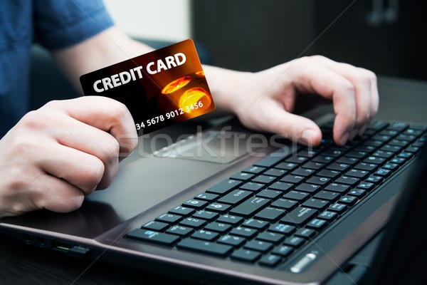 Man holding colorful credit card. Hands on computer keyboard Stock photo © simpson33
