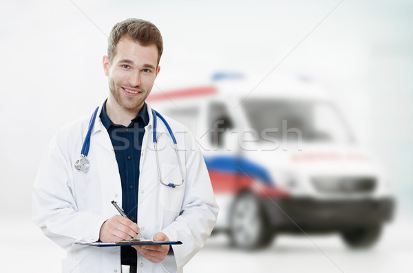 Doctor in hospital with ambulance in background Stock photo © simpson33
