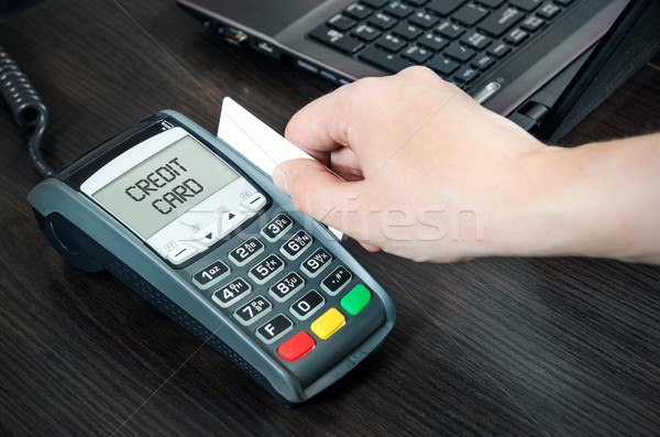 Man pays with credit card. Swiping plastic card through terminal Stock photo © simpson33