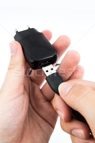Man using black USB phone charger Stock photo © simpson33