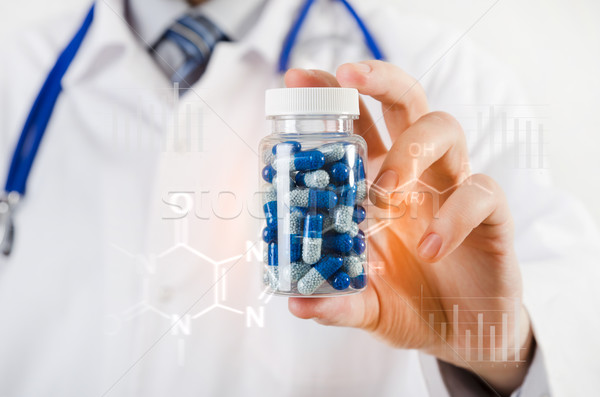 Doctor scientist invented new drug, holds capsule in hands Stock photo © simpson33