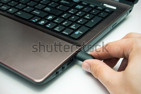 Hand connecting USB cable to laptop Stock photo © simpson33