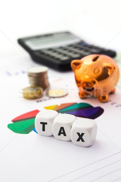 Tax composition on white dices. Piggybank in background Stock photo © simpson33