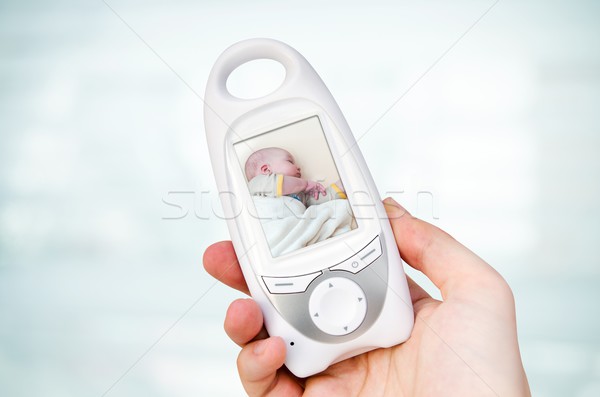 Hand holding video baby monitor for security of the baby  Stock photo © simpson33