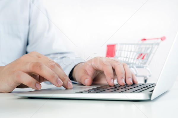 Man using laptop for internet shopping. Composition with shoppin Stock photo © simpson33