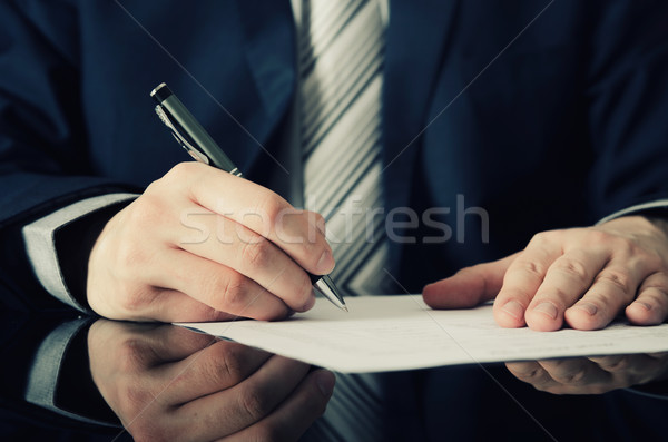 Businessman signs a contract Stock photo © simpson33