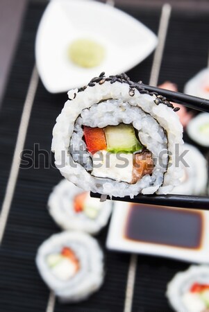 Hand holding sushi on sticks Stock photo © simpson33