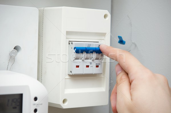 Man switches automatic fuse. Electric equipment close up Stock photo © simpson33