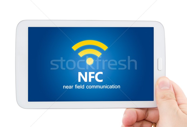 Hand holding tablet with NFC. Technology of wireless payment met Stock photo © simpson33