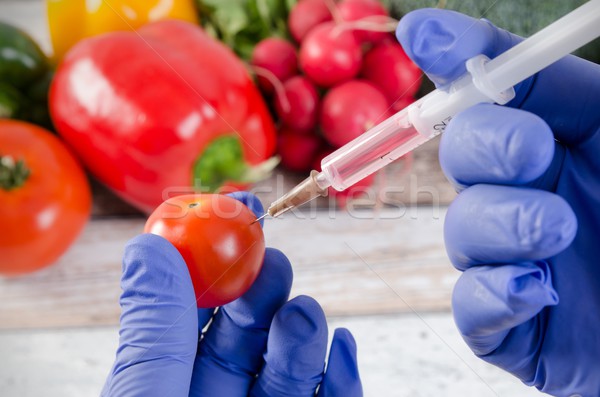 Analyst injects liquid into apple. Genetically modified food con Stock photo © simpson33