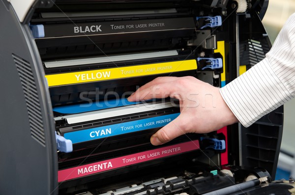 Man puts toner in the printer Stock photo © simpson33