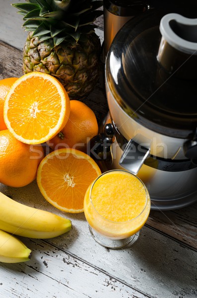 Fresh juice and juicer. Photo on wooden background  Stock photo © simpson33