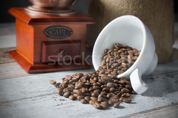 Coffee grain spill from a cup. Jute bag of roasted beans and mil Stock photo © simpson33