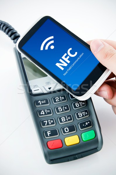Contactless payment card with NFC chip in smart phone Stock photo © simpson33