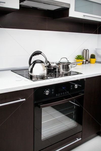 Saucepan, kittle and frying pan in modern kitchen Stock photo © simpson33
