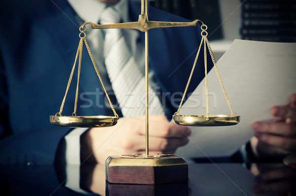 Weight scale of justice, lawyer in background Stock photo © simpson33