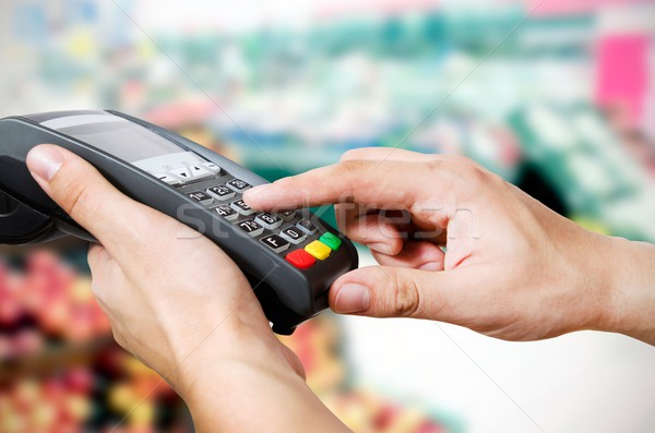 Hand with credit card swipe through terminal for sale in superma Stock photo © simpson33