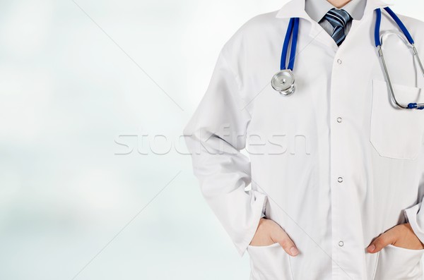 Doctor with hands in pocket on blurred background. Copyspace med Stock photo © simpson33