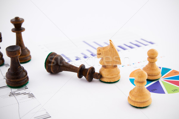 Chess pieces on business background. Company strategic behavior Stock photo © simpson33