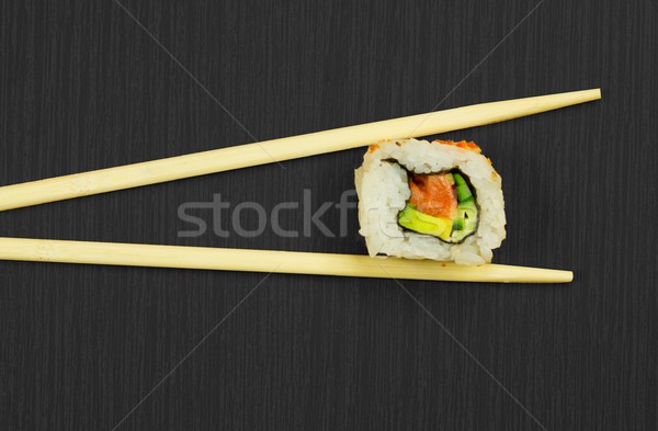 Sushi and sticks isolated on black wooden board Stock photo © simpson33