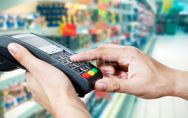 Hand with credit card swipe through terminal for sale in superma Stock photo © simpson33