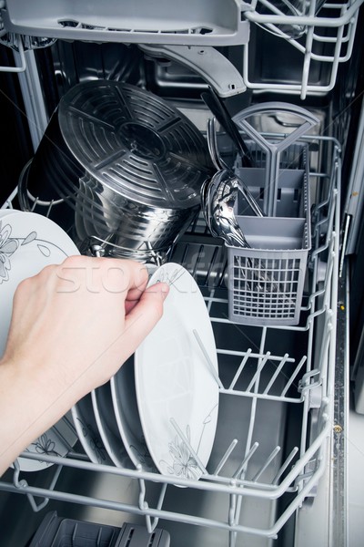 Hand takes plate from dishwasher Stock photo © simpson33