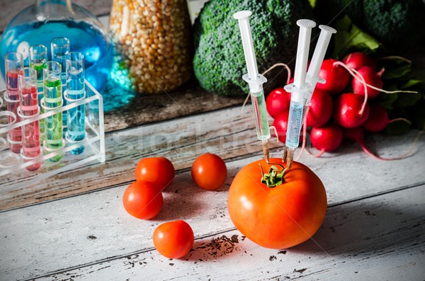 Three syringes in tomato. Genetically modified food concept. Stock photo © simpson33