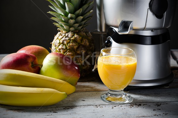 Fresh juice and juicer. Photo on wooden background  Stock photo © simpson33