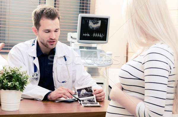 Doctor showing baby ultrasound image to pregnant woman Stock photo © simpson33
