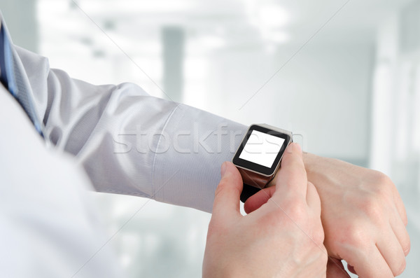 Man using smartwatch with e-mail notifier Stock photo © simpson33