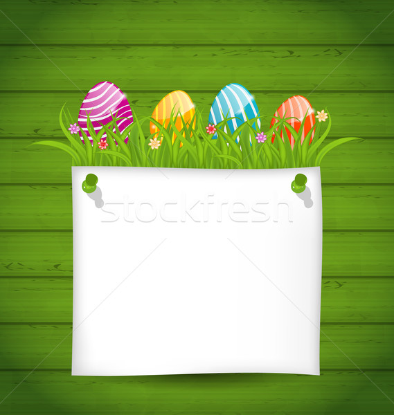  Easter colorful eggs in green grass with empty paper card for y Stock photo © smeagorl