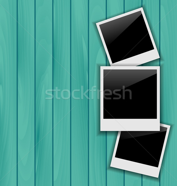 Three blank photo frames on wooden background Stock photo © smeagorl